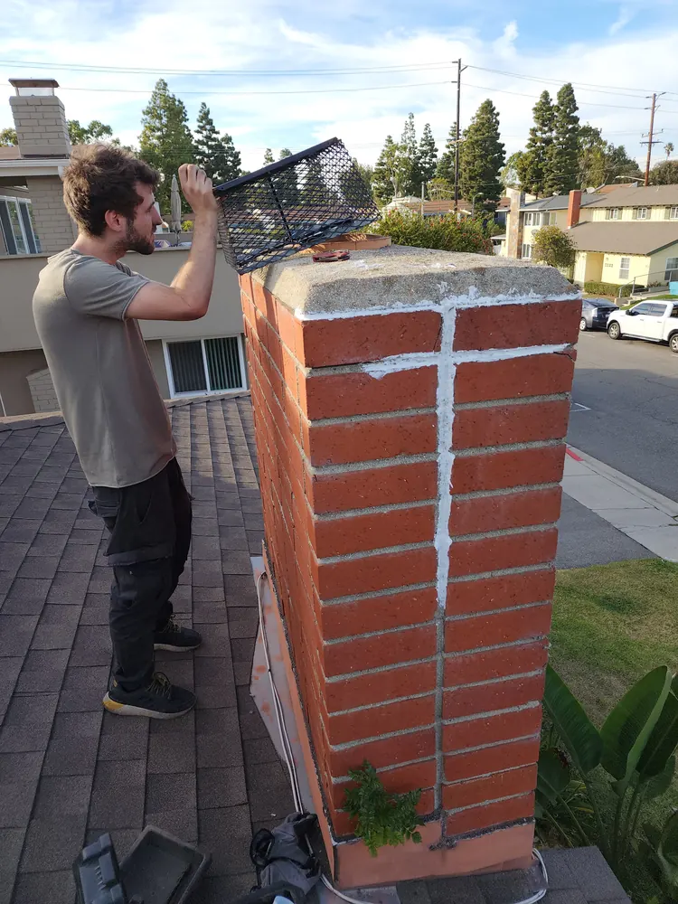 Technician completing focused work on a residential chimney crown