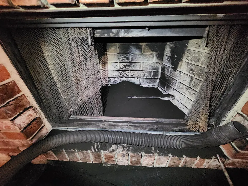 Soot-stained firebox masonry ready for inspection and focused repair