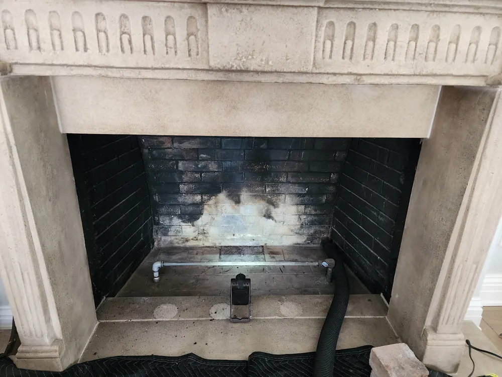 Ornate fireplace prepared for firebox cleaning